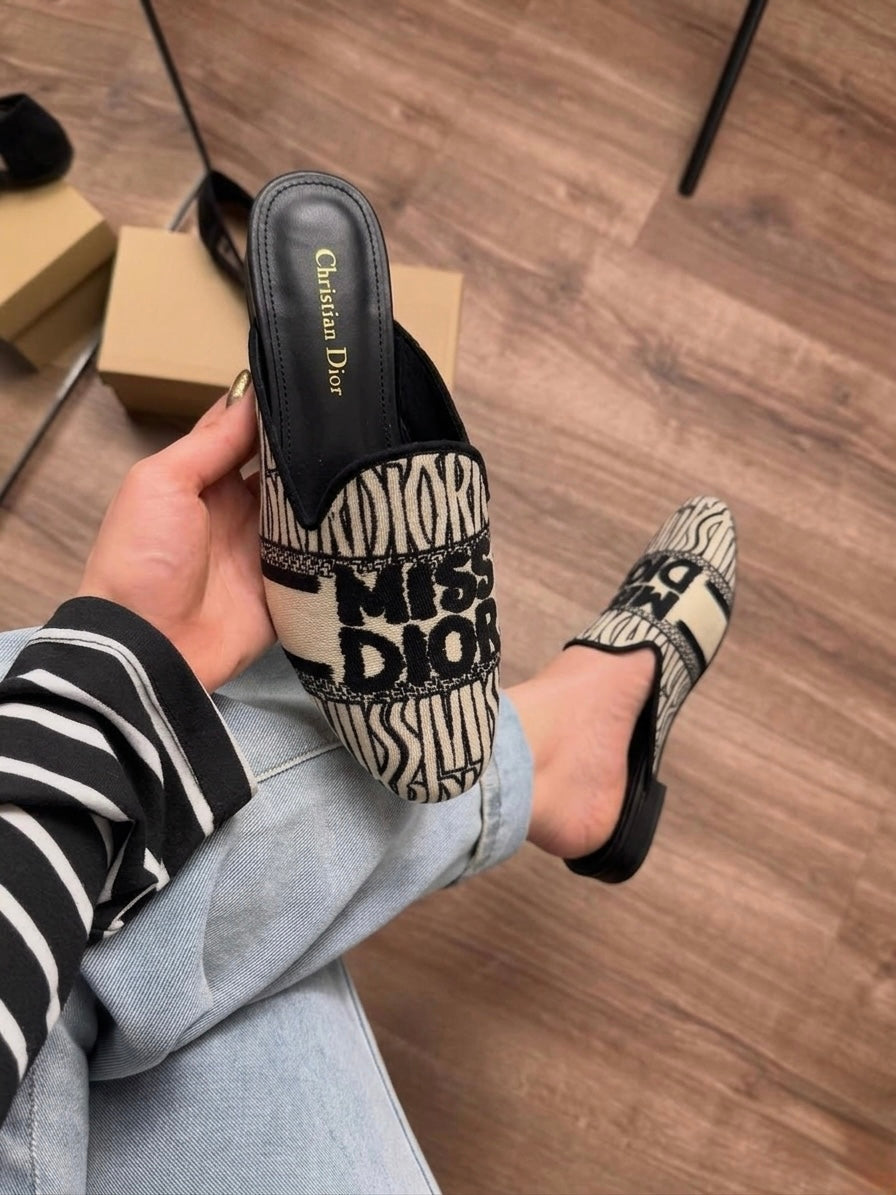 Miss D off Mule Slide Clogs